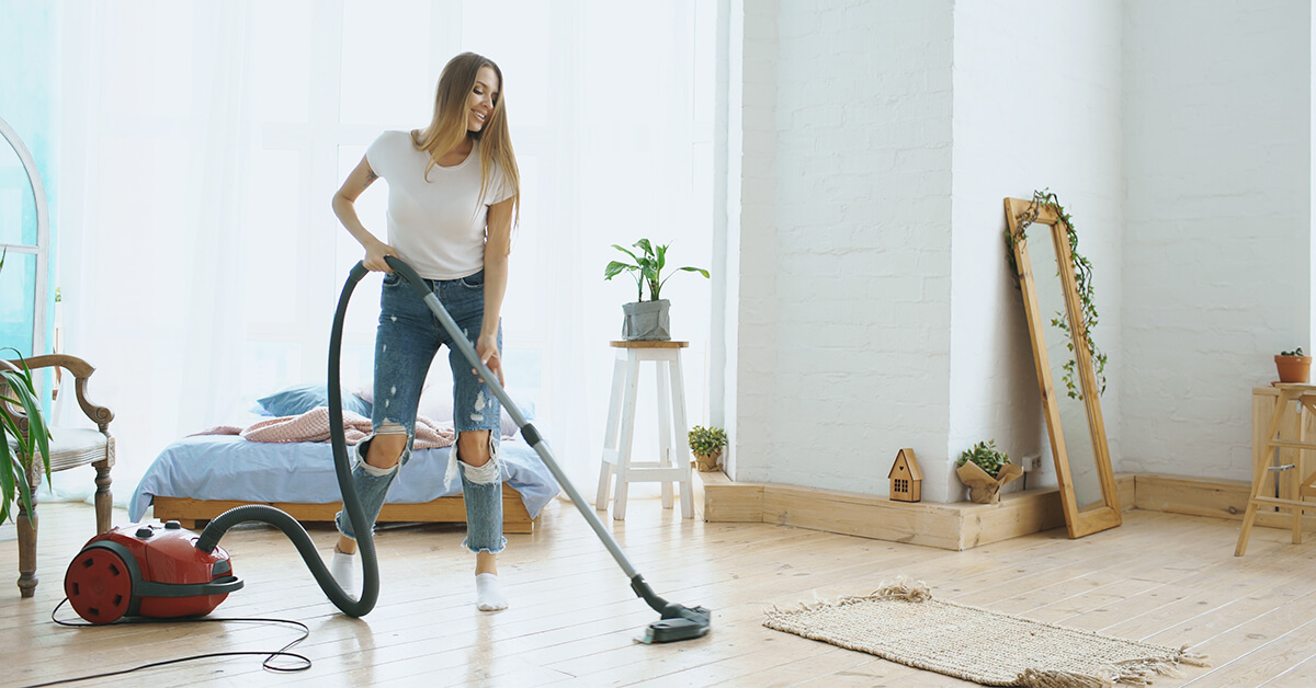person vacuuming floor