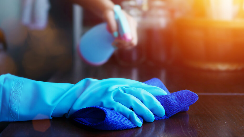 person cleaning table